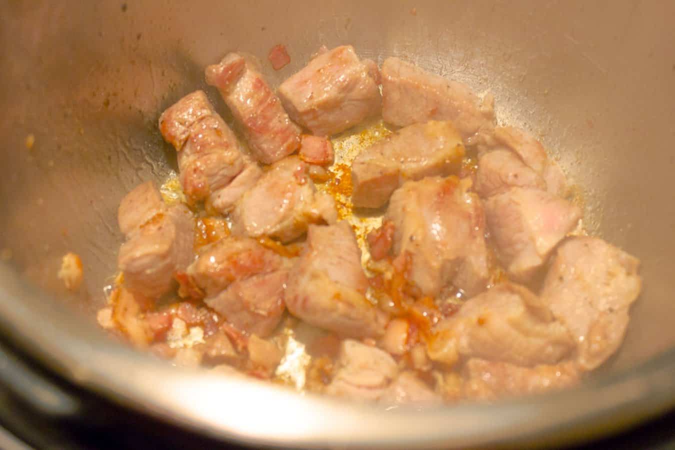 Pork and bacon being browned for Instant Pot Pressure Cooker Red Pork Chili