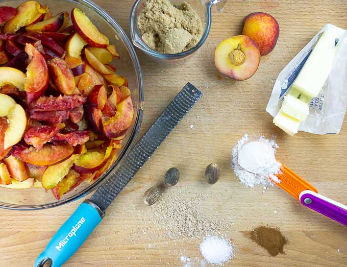 ingrediants for Fresh Peach Pie With Crumb Topping on a wooden surface