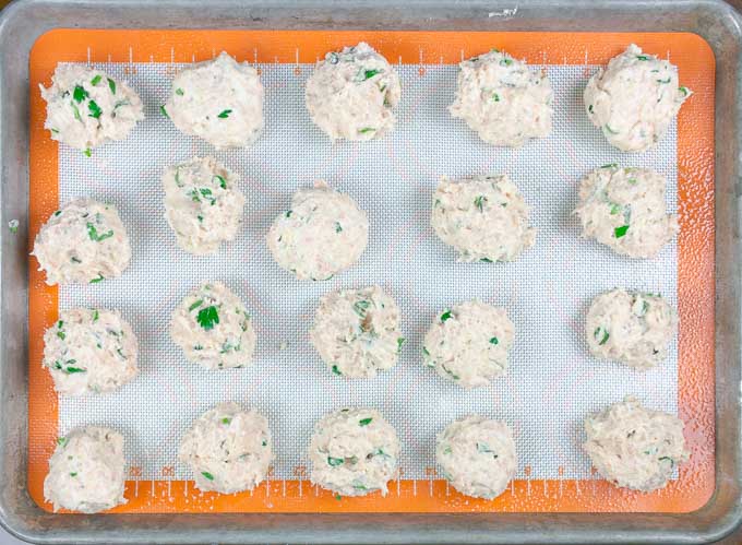 uncooked chicken ricotta meatballs on a baking sheet