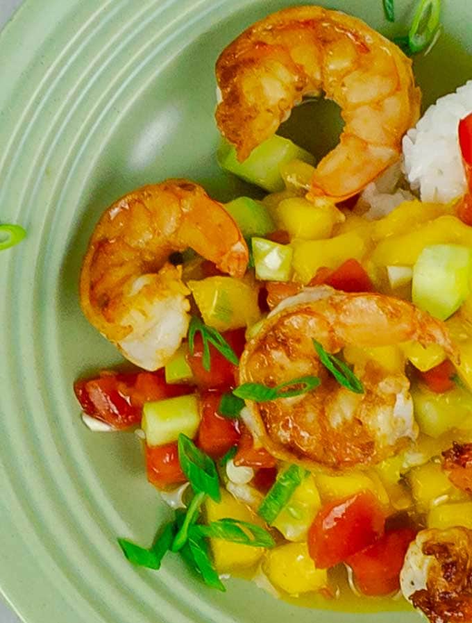 Garlic Shrimp with Mango Cucumber Salsa and Coconut Rice on green plate.