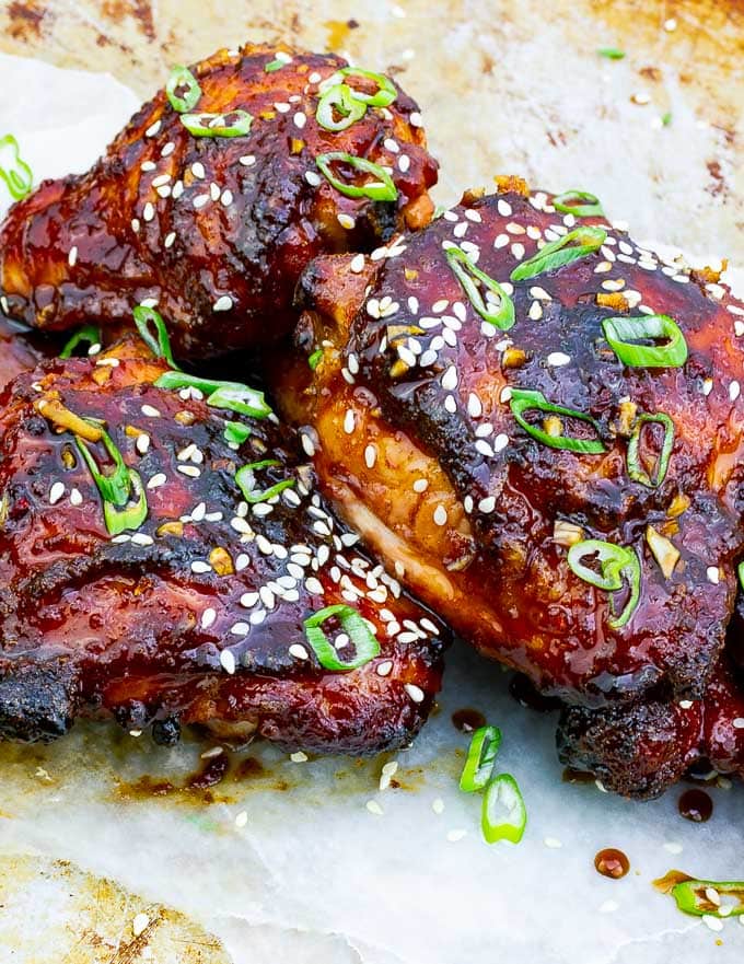 three pieces of Sticky Asian Grilled Chicken Thighs on white background