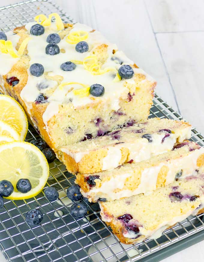 three slices of Lemon Blueberry Sour Cream Pound Cake on wire rack