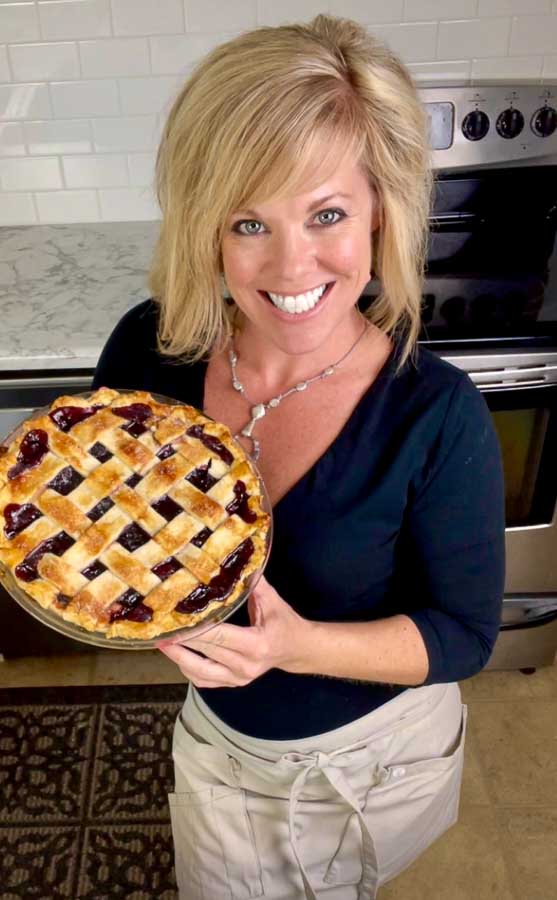 Jennifer holding The Best Cherry Pie Recipe with Homemade Filling
