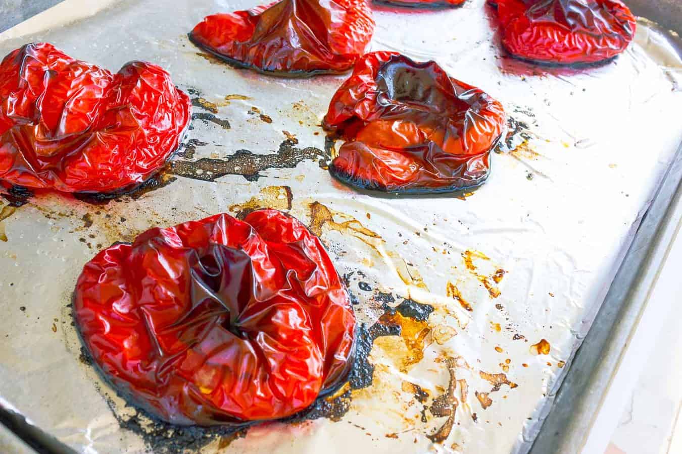 Roasted Red peppers cut side down on cookie sheet