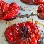 roasted red peppers shown on foil lined cookie sheet