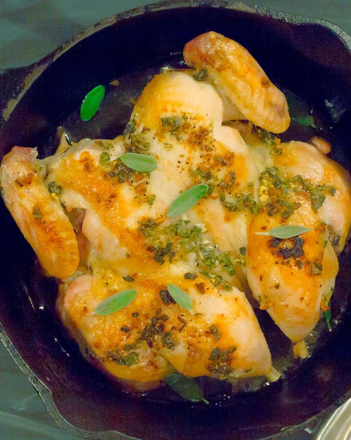 Whole Roasted Spatchcock Chicken with Sage Brown Butter in black cast iron dutch oven