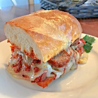 The Bomb Italian Sausage Sandwich on white plate