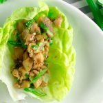 one Asian Chicken Lettuce Wrap on white plate