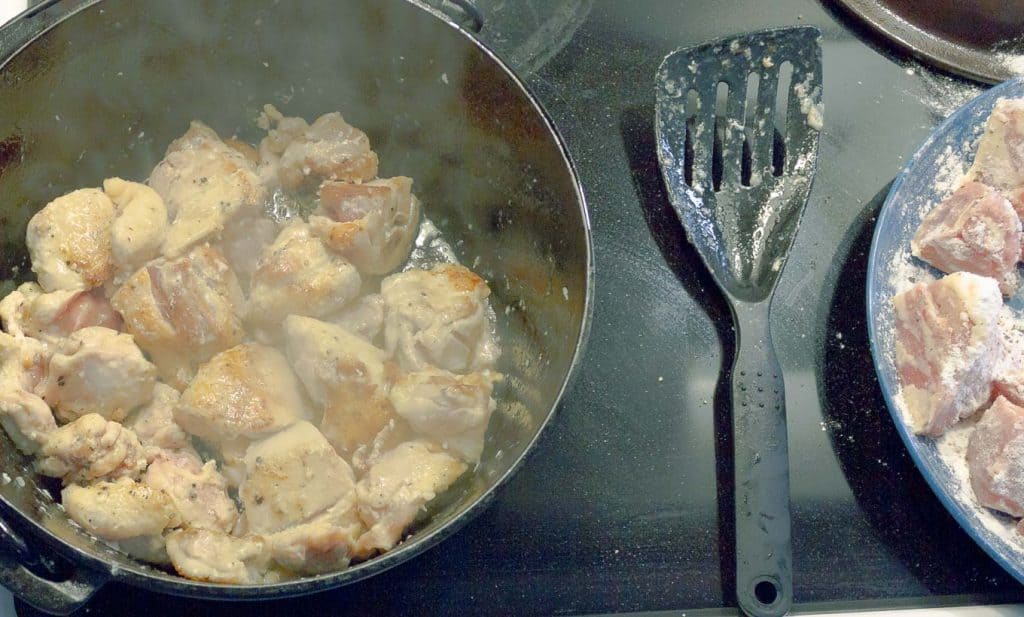 Slow Cooker Chicken and Dumplings from Scratch chicken being browned in dutch oven