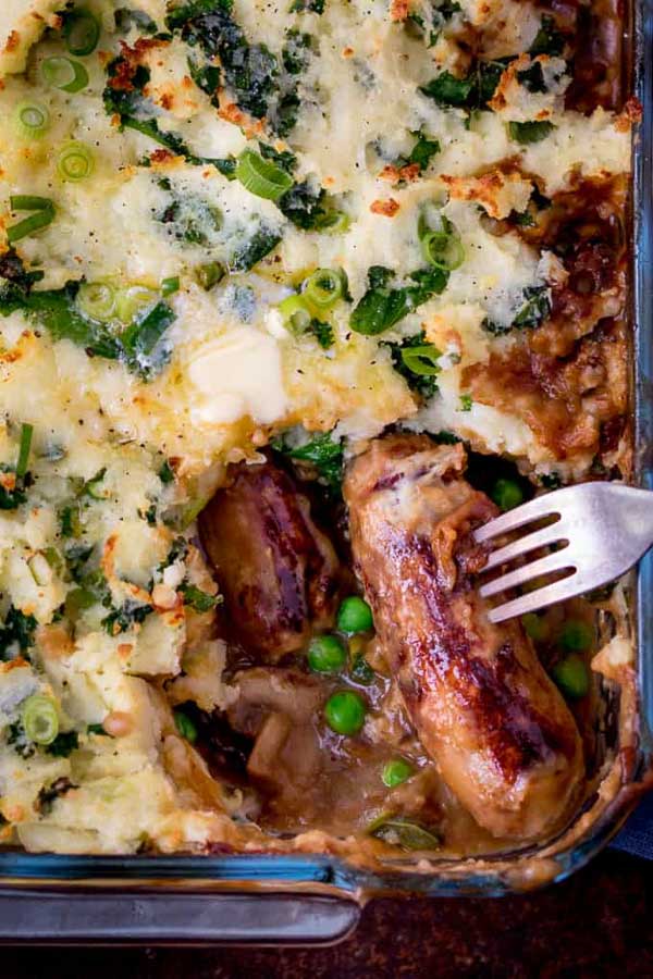 Sausage and Colcannon Bake with a sausage on a fork
