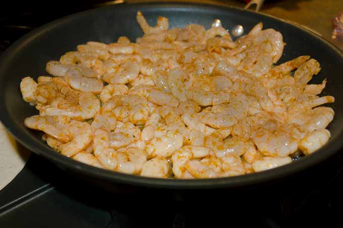 shrimp being sauteed in a skillet
