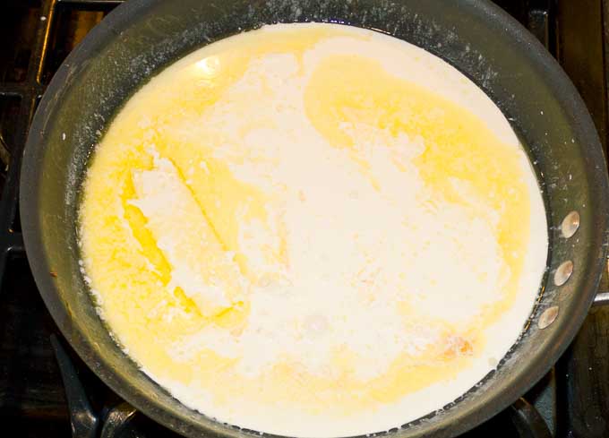 butter melting and cream in a large pan.