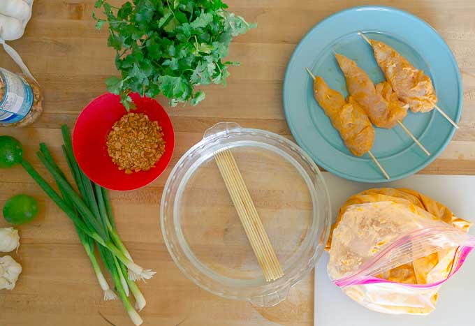 Thai Chicken Satay Skewers being marinated and put on a skewer