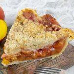 A piece of Fresh Peach Pie With Crumb Topping