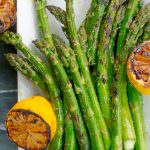 Grilled Asparagus with Grilled Lemon on white platter