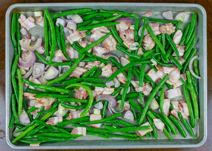 raw Fresh Roasted Green Beans with Bacon and Shallots on metal baking sheet