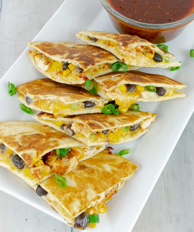 quartered Chipotle Barbecue Sauce Chicken Quesadillas on white platter