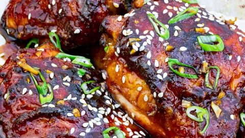 three Sticky Asian Grilled Chicken Thighs on white background