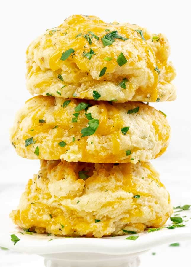 three Italian Herb Garlic Cheddar Biscuits stacjed on top of each other
