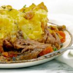 close up of a white plate of Shredded Beef Dutch Oven Shepherd's Pie