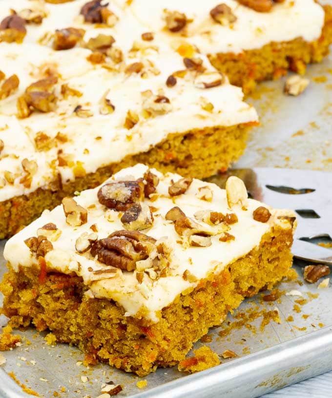 A piece of easy carrot sheet cake recipe from scratch on a cookie sheet