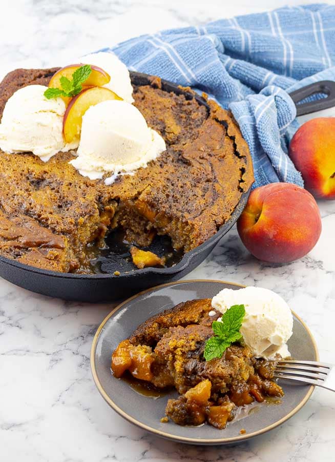 grilled fresh peach cast iron skillet cake and a plate of the cake with ice cream