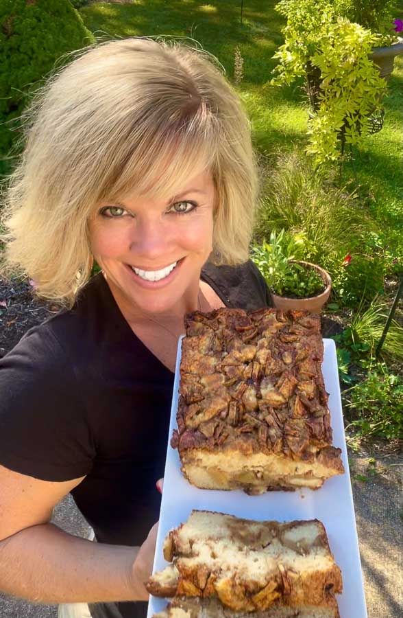 Jennifer holding a tray of apple cinnamon swirl loaf