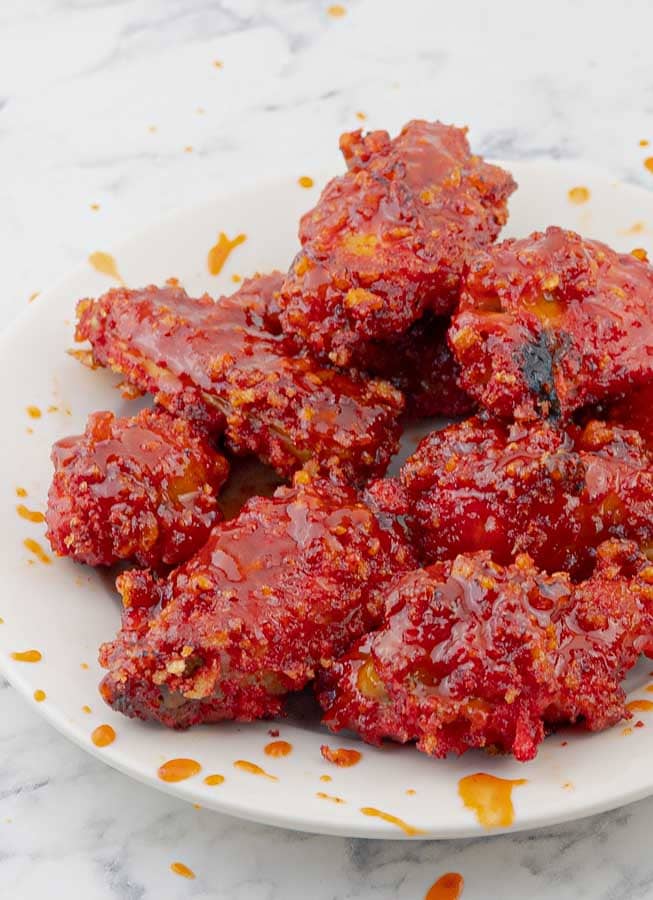 white plate of Flamin' Hot Cheetos Wings with Honey Sriracha Sauce