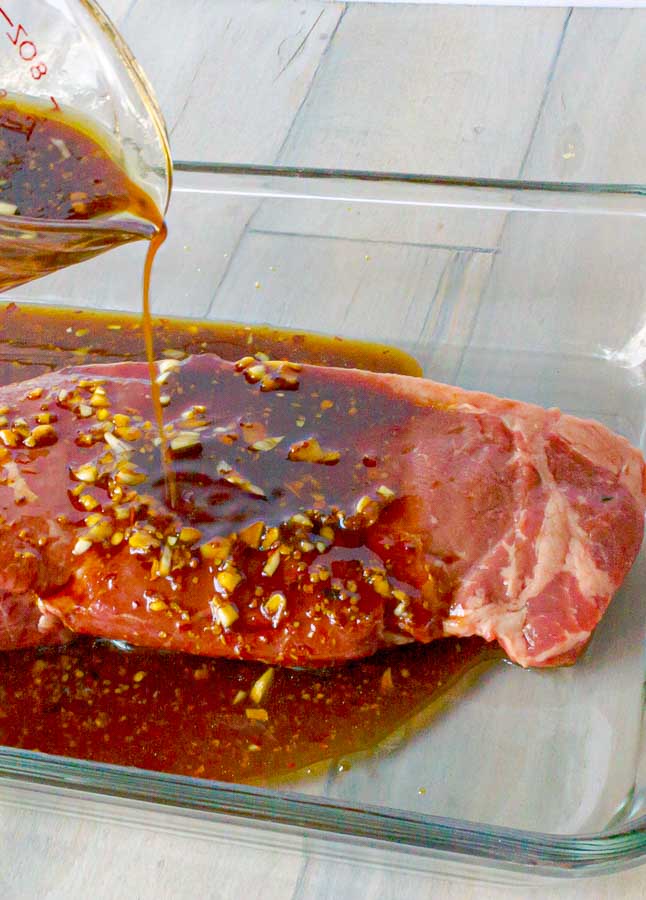 The BEST Teriyaki Marinade being poured over a sirloin steak