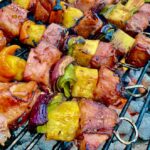 square close up pic of Bourbon Bacon Ham and Pineapple Kabobs on the Grill