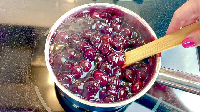 Homemade Cherry Pie Filling being stirred in a sauce pan