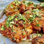 square picture of Grilled Italian Chicken Thighs on metal baking sheet