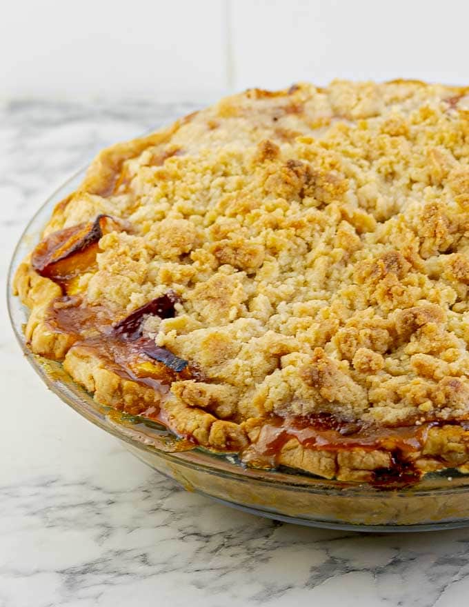 Fresh Peach Pie With Crumb Topping on white granite