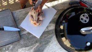 Jennifer cutting out the backbone of a chicken