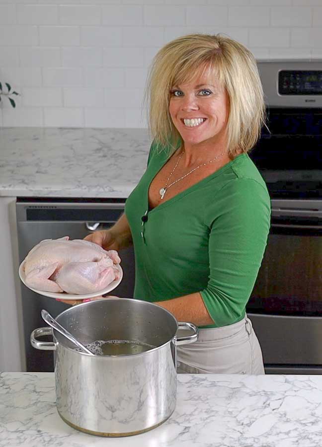 Jennifer holding a chicken ready to go into the brine
