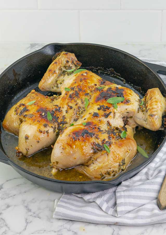cast iron skillet with WHOLE ROASTED SPATCHCOCK CHICKEN WITH SAGE BROWN BUTTER