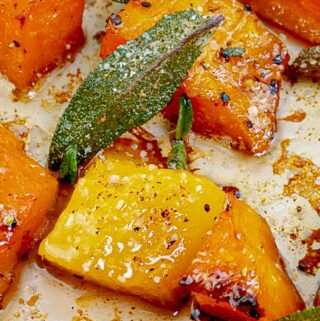 close up of Easy Roasted Butternut & Acorn Squash with Sage Brown Butter on metal baking sheet